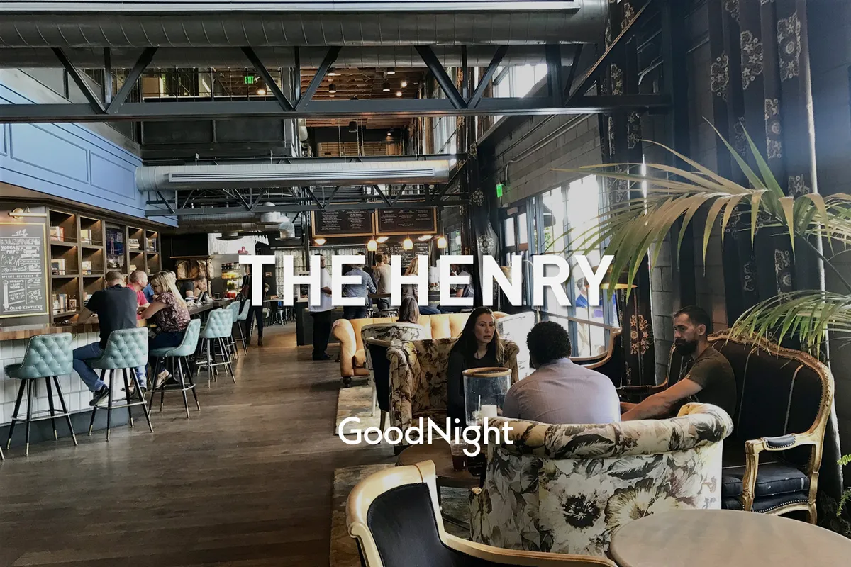 An inviting interior bar and lounge area where guests are socializing, enjoying drinks, and relaxing. Decorative plants and warm lighting create a vibrant yet welcoming atmosphere, suggesting a place to unwind or celebrate after a day on the golf course.