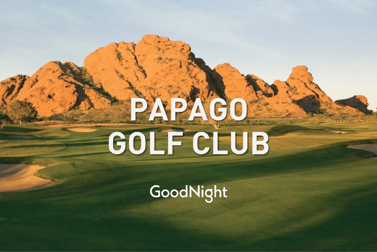 A sweeping view of a golf course set against dramatic rock formations and a wide, open sky. The scene captures the distinctive Arizona landscape, inviting golfers to enjoy both the sport and the natural beauty. The tranquility of the course is highlighted, with no players visible, allowing viewers to imagine themselves on the green.